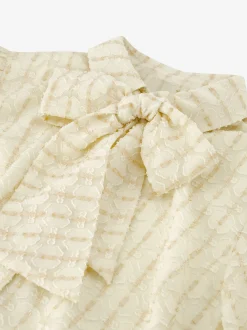 Losvallende blouse met pofmouwen en strikdetail