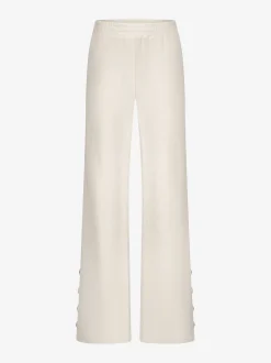 Losvallende broek met logo patroon en sierknopen