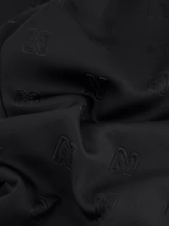 Losvallende broek met logo patroon en sierknopen